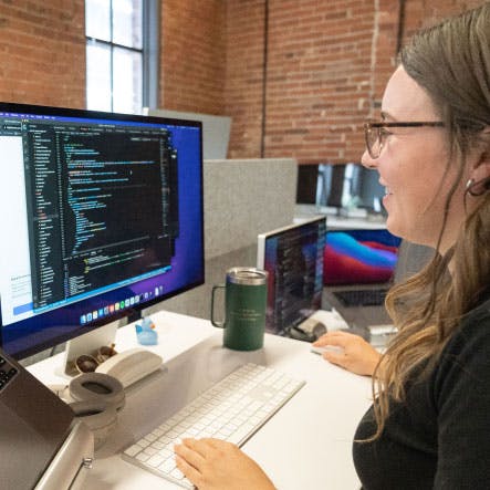 Women on laptop coding.